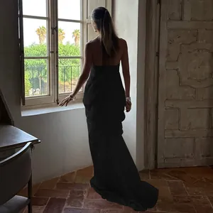 Detail of elegant backless design and draped pleats on this black mesh maxi dress
