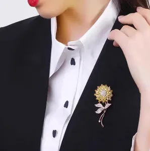 Elegant sunflower brooch with yellow crystals and pearls pinned on a formal suit blazer