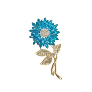 Elegant gold sunflower brooch featuring sky blue rhinestones and white crystal accents