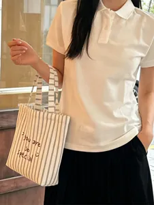 Striped canvas tote bag with 'you are so special' embroidery and casual outfit
