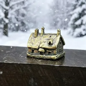 Detailed close-up of a vintage bronze snow-covered house miniature for bonsai landscaping