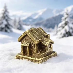Close-up of a miniature bronze pagoda statue for bonsai decor on snowy background