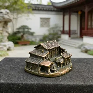 Close-up of a miniature vintage bronze pagoda showing detailed tiled roofs and windows