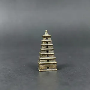 Close-up of a 7-tier miniature metal pagoda with vintage bronze finish and solid base