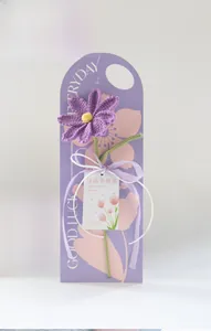 Handmade purple knitted daisy flower with Mother's Day gift card and white ribbon