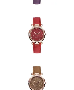 Detail view of starry dial quartz watches with rose gold faceted cases and leather straps