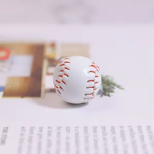 Miniature white baseball keychain pendant with red stitching and leather texture