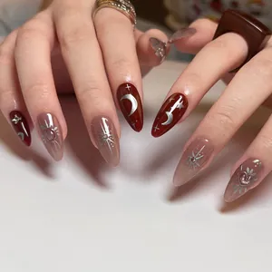 Elegant wine red press-on nails featuring silver celestial star and moon patterns on hands