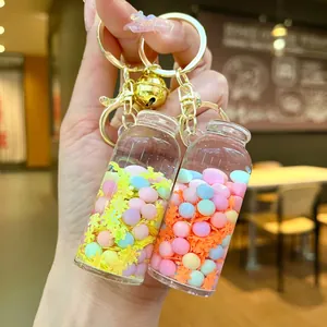 Close-up of wishing bottle keychain with macaron beads, sequins and a gold bell