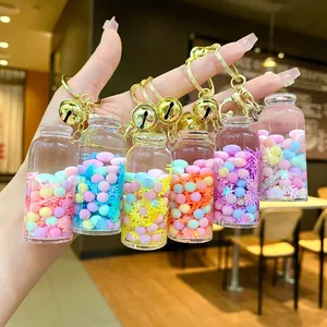 Close-up of colorful liquid drifting bottle keychains with glitter and gold metal rings