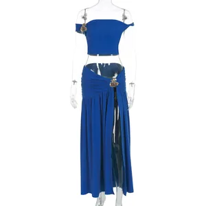 Detail of royal blue two-piece set featuring gold flower hardware and side ruching