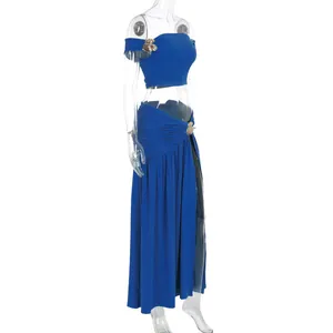Detail of royal blue beach set featuring gold flower buckle and side slit design
