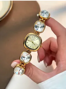 Detail view of a luxury gold women's watch featuring a crystal-embellished bracelet strap