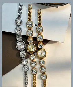 Detail of luxury women watch with crystal-encrusted chain links and rectangle dial