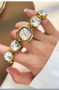 Detail view of GEDI gold square watch with crystal bracelet strap and Roman numerals