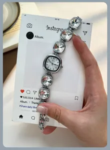 Macro view of GEDI silver quartz watch featuring luxury sparkling rhinestone chain strap