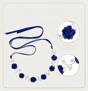 Macro detail of handmade dark blue clay rose with pearls and woven silver wire
