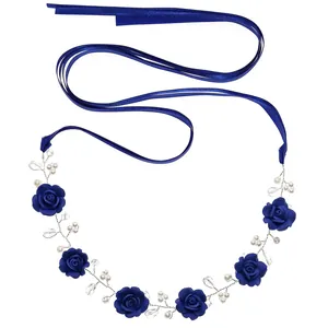 Blue fabric rose headband with white pearls and satin ribbons on a white background