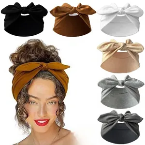 Detail showing elastic knotted bow headbands in black, brown, white and grey tones