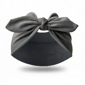 Detail of dark grey knitted headband showing soft fabric texture and knotted bow design