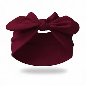 Close-up of deep red knotted bunny ear headband with soft elastic knit texture