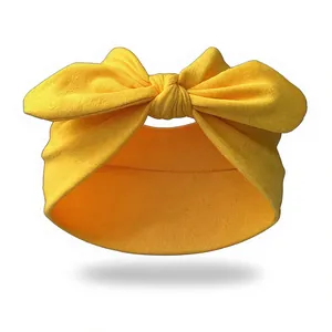 Close-up of bright yellow elastic yoga headband with large decorative knot detail
