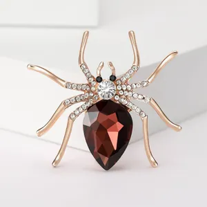 Exquisite rose gold spider brooch with red teardrop crystal and white rhinestones