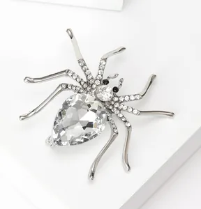 Close-up of alloy spider brooch with crystal rhinestones and pear-shaped center stone