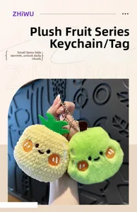 Detailed view of plush pineapple and green fruit pendants with cute embroidered faces