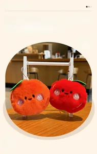 Macro detail of plush fruit pendants featuring cute orange and apple designs with beads