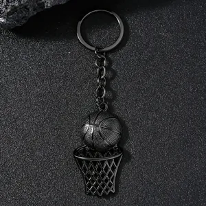 Macro shot of matte black basketball hoop keychain on a textured stone background