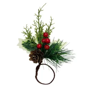 Christmas napkin ring with red berries, pine cones and artificial needles on white background