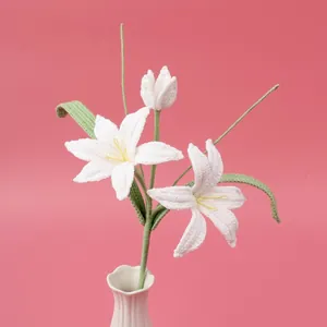 Handmade crochet white lily bouquet with blooming flowers in a ceramic vase