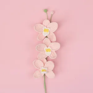 Handmade crochet orchid flower branch in pink yarn with three blossoms and green buds