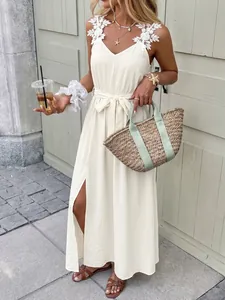Detailed view of floral lace straps and V-neckline on this white summer maxi dress