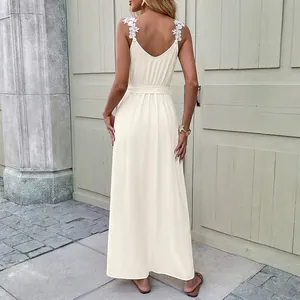 Elegant beige floor-length summer dress with floral lace straps and a waist tie