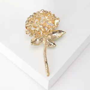 Elegant gold rose flower brooch with green enamel finish and secure safety clasp