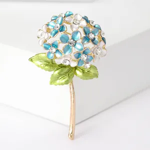 Macro detail of blue and white enamel hydrangea brooch with clear rhinestones