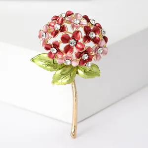 Macro detail of enamel hydrangea brooch with pink flowers and sparkling crystal centers