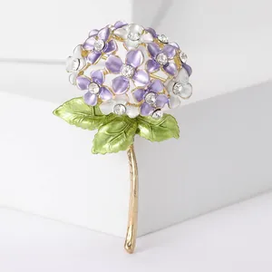 Macro detail of enamel hydrangea brooch with purple petals and sparkling crystals