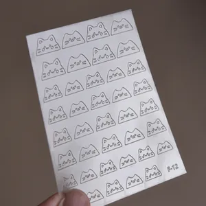 Detailed view of F-12 silver cat head hollow nail art stickers on a transparent sheet