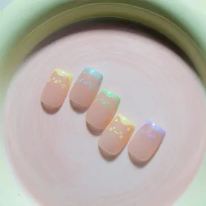 Detail view of colorful cat-themed press-on nails with cute facial patterns and macaron hues