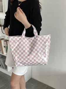 Close-up of pink checkered tote bag with large capacity and glossy waterproof finish