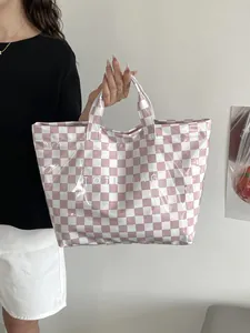 Detail view of the waterproof pink and white checkered PVC surface with Tote Bag text