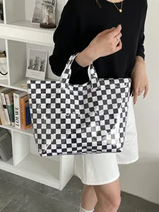 Detailed view of the checkered tote bag with a waterproof glossy finish and large capacity