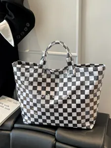 Detail shot of a large checkerboard tote bag with TOTE BAG lettering in white