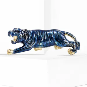 Close-up of roaring tiger brooch with deep blue enamel coating and golden plating