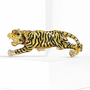 Detailed macro shot of a dynamic golden tiger brooch with black enamel tiger stripes
