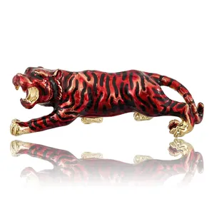 Red and gold roaring tiger brooch with enamel finish and black stripes on white base