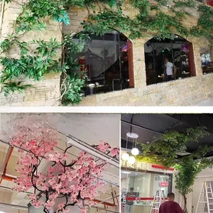 Detail view of decorative artificial green vine and cherry blossom tree for interiors